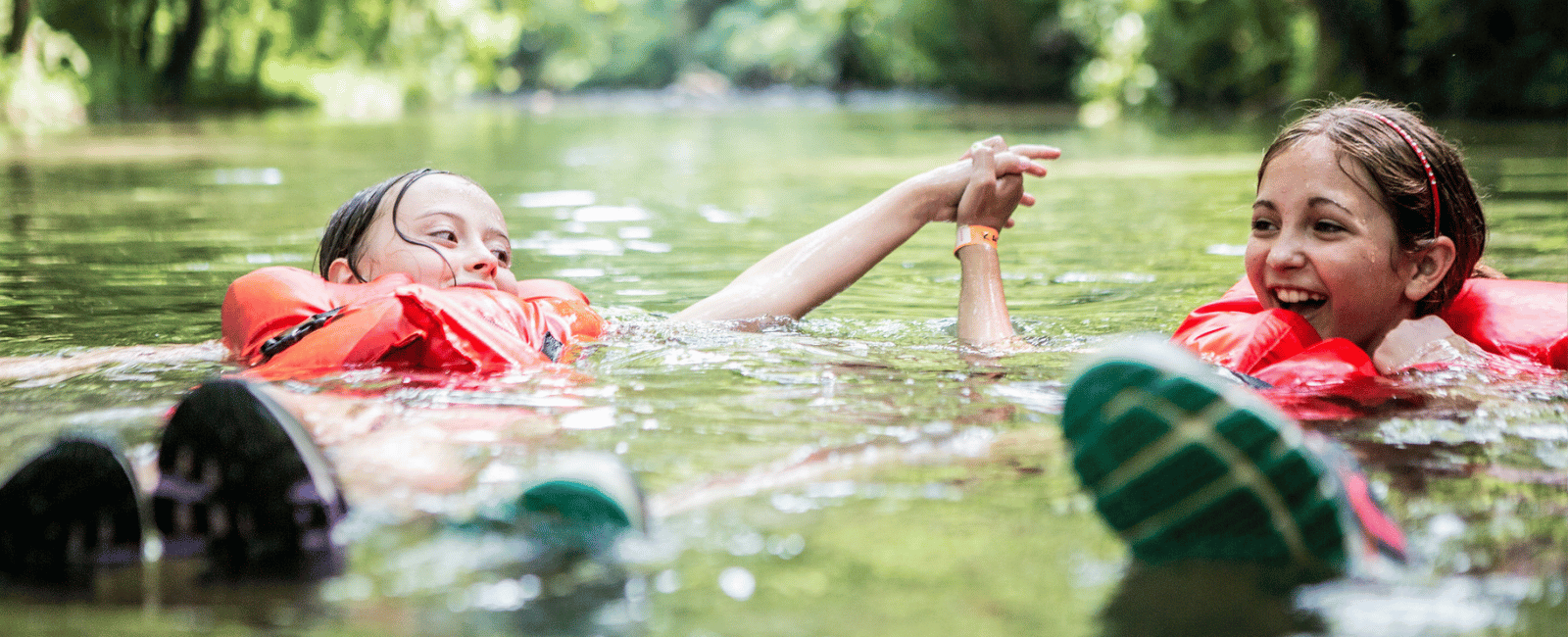 Two 4-H members safely explore a river ripiarian area