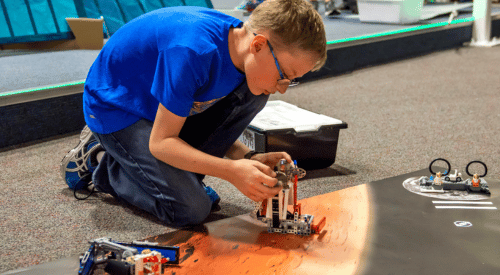 A 4-h member builds a robot as part of a 4-H technology project