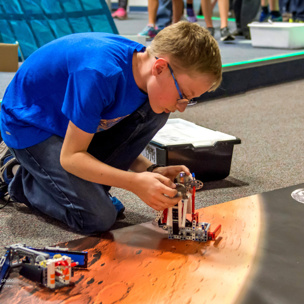 Photo of a 4-h youth working on electronics