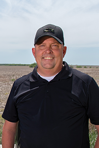 Spencer Casey stands in a field at that Harold and Olympia Lonsinger Sustainability Research Farm